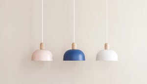 Three pendant lights in pink navy and white with oak tops